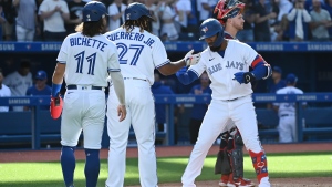 Toronto Blue Jays' Teoscar Hernandez, right, celebrates with Bo Bichette (11) and Vladimir Guerrero Jr. (37) after hitting a three-run home run in the fourth inning of an American League baseball game against the Minnesota Twins in Toronto on Saturday, Sept. 18, 2021. THE CANADIAN PRESS/Jon Blacker