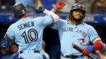 Toronto Blue Jays second baseman Marcus Semien (10) celebrates his solo home run with teammate Vladimir Guerrero Jr. (27) during fifth inning MLB baseball action against the Baltimore Orioles, in Toronto, Sunday, Oct. 3, 2021. THE CANADIAN PRESS/Frank Gunn 