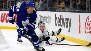Toronto Maple Leafs defenseman Rasmus Sandin, left, takes the puck away from a fallen Los Angeles Kings left wing Arthur Kaliyev during the second period of an NHL hockey game in Los Angeles, Wednesday, Nov. 24, 2021. (AP Photo/Alex Gallardo) 
