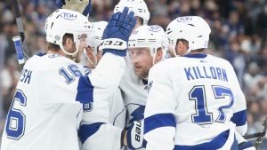 Tampa Bay Lightning's Steven Stamkos, second right, celebrates his goal against the Toronto Maple Leafs with teammates Taylor Raddysh, left, and Alex Killorn, right, during first period NHL hockey action in Toronto, on Thursday, December 9, 2021.THE CANADIAN PRESS/Chris Young