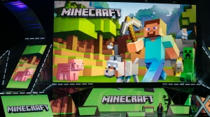 Lydia Winters shows off Microsoft's "Minecraft" built specifically for HoloLens at the Xbox E3 2015 briefing before Electronic Entertainment Expo, June 15, 2015, in Los Angeles. Security experts around the world raced Friday, Dec. 10, 2021, to patch one of the worst computer vulnerabilities discovered in years, a critical flaw in open-source code widely used across industry and government in cloud services and enterprise software. Cybersecurity experts say users of the online game Minecraft have already exploited it to breach other users by pasting a short message into in a chat box. (AP Photo/Damian Dovarganes, File)