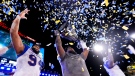 Winnipeg Blue Bombers offensive lineman Stanley Bryant (66) hoists the trophy with defensive end Jackson Jeffcoat (94) as they celebrate defeating the Hamilton Tiger-Cats in the 108th CFL Grey Cup in Hamilton, Ont., on Sunday, December 12, 2021. THE CANADIAN PRESS/Nathan Denette