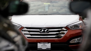 A Hyundai Santa Fe sits in a Hyundai car dealership in Des Plaines, Ill., on Oct. 4, 2012. U.S. auto safety regulators have stepped up a series of investigations into engine fires that have plagued Hyundai and Kia vehicles for more than six years. The National Highway Traffic Safety Administration says a new engineering analysis investigation covers more than 3 million vehicles from the 2011 through 2016 model years. (AP Photo/Nam Y. Huh, File)