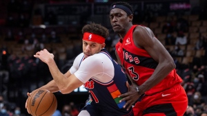 Philadelphia 76ers' Seth Curry (left) drives past Toronto Raptors' Pascal Siakam during second half NBA basketball action in Toronto on Tuesday, December 28, 2021. THE CANADIAN PRESS/Chris Young