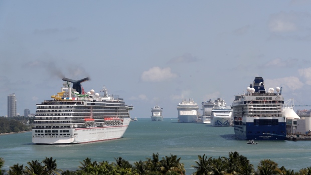 FILE - Cruise ships float at PortMiami, on April 7, 2020, in Miami. The U.S. Centers for Disease Control and Prevention is now warning people not to cruise regardless of their vaccination status because of an increase in cases fueled by the omicron variant detected in ships. (AP Photo/Lynne Sladky, File)