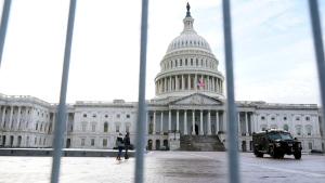 The U.S. Capitol is framed by security barricades, Wednesday, Jan. 5, 2022, in Washington. Thursday marks the first anniversary of the Capitol insurrection, a violent attack that has fundamentally changed Congress and prompted widespread concerns about the future of American democracy. (AP Photo/Mariam Zuhaib)