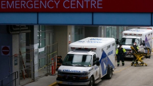 Paramedics push a gurney towards an ambulance outside a Toronto Hospital on Wednesday, January 5, 2022.THE CANADIAN PRESS/Chris Young 
