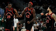 Toronto Raptors' Pascal Siakam reacts with teammate Chris Boucher and Chris Boucher during the final minute in the second half of an NBA basketball game against the Milwaukee Bucks Saturday, Jan. 15, 2022, in Milwaukee. The Raptors won 103-96. (AP Photo/Morry Gash)