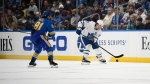 Toronto Maple Leafs center John Tavares (91) moves the puck away from St. Louis Blues left wing James Neal (81) during the second period of an NHL hockey game on Saturday, Jan. 15, 2022, in St. Louis. (AP Photo/Arnold J. Ward) 