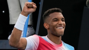 Felix Auger-Aliassime of Canada celebrates after defeating Emil Ruusuvuori of Finland in their first round match at the Australian Open tennis championships in Melbourne, Australia, Tuesday, Jan. 18, 2022. (AP Photo/Simon Baker) 