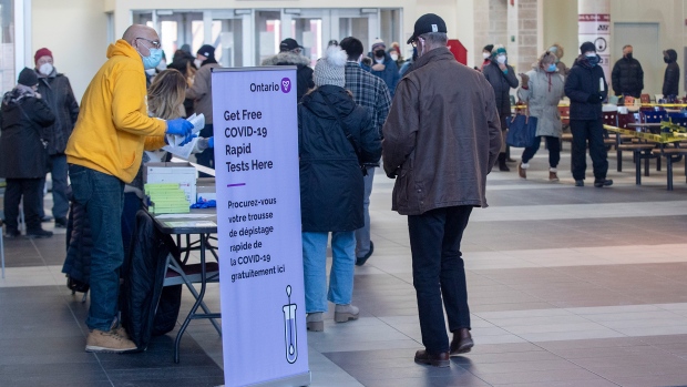 People line up for free COVID-19 Rapid Antigen Test kits provided by the government of Ontario, at Queen’s University in Kingston, Ont., on Tuesday January 11, 2022. THE CANADIAN PRESS/Lars Hagberg
