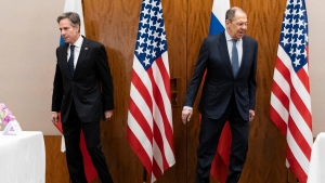 US Secretary of State Antony Blinken, left, and Russian Foreign Minister Sergey Lavrov move to their seats before their meeting, Friday, Jan. 21, 2022, in Geneva, Switzerland. (AP Photo/Alex Brandon, Pool)