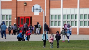 Parents pick up their children as they are dismissed from Dixie Public School during the COVID-19 pandemic in Mississauga, Ont., on Monday, November 22, 2021.  THE CANADIAN PRESS/Nathan Denette 