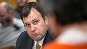 FILE - Sedgwick County District Attorney Marc Bennett looks toward Daniel Perez as Perez is sentenced in Sedgwick District Court in Wichita, Kan., on March 24, 2015. Bennett said this week that the state's "stand your ground law" prevented him from charging the local juvenile center's employees in the death of 17-year-old Cedric Lofton, who'd been restrained on the ground on his stomach, shackled and handcuffed for more than 30 minutes.(AP Photo/The Wichita Eagle, Mike Hutmacher, File)