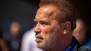 FILE - Former California Gov. Arnold Schwarzenegger looks at a Super Huey, a helicopter used for dropping water at fires, during a tour at McClellan Air Force Base in Sacramento, Calif., on Aug. 1, 2019. Schwarzenegger was involved in a multi-vehicle crash late Friday, Jan. 21, 2022, afternoon in the Brentwood district of Los Angeles. (Daniel Kim/The Sacramento Bee via AP, Pool, File)