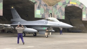 In this image taken from video, Taiwanese Air Force personnel scramble to take off in an F-16V fighter jet during a drill in Chiayi in southwestern Taiwan, Wednesday, Jan. 5, 2022. (AP Photo)