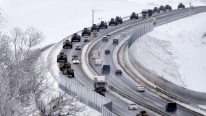 FILE - A convoy of Russian armored vehicles moves along a highway in Crimea, on Jan. 18, 2022. Russia's present demands are based on Putin's purported long sense of grievance and his rejection of Ukraine and Belarus as truly separate, sovereign countries but rather as part of a Russian linguistic and Orthodox motherland. (AP Photo, File)