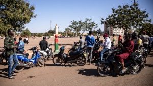 People begin to gather spontaneously Place de la Nation in Burkina Faso's capital Ouagadougou Sunday Jan. 23, 2022. Witnesses are reporting heavy gunfire at a military base raising fears that a coup attempt is underway. (AP Photo/Sophie Garcia)