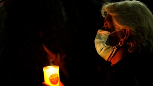 A woman holds a candle during a national protest against the murder of journalist Lourdes Maldonado and freelance photojournalist Margarito MartÃ­nez, in Mexico City, Tuesday, Jan. 25, 2022. Mexico's Interior Undersecretary Alejandro Encinas said recently that more than 90% of murders of journalists and rights defenders remain unresolved, despite a government system meant to protect them. (AP Photo/Eduardo Verdugo)