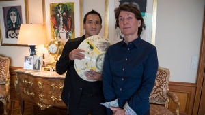 Marina Picasso, right, granddaughter of artist Pablo Picasso, and her son Florian Picasso pose with a ceramic art-work of Pablo Picasso in Cologny near in Geneva, Switzerland, Tuesday, Jan. 25, 2022. Heirs of Pablo Picasso, the famed 20th-century Spanish artist, are vaulting into 21st-century commerce by selling 1,010 digital art pieces of one of his ceramic works that has never before seen publicly riding a fad for crypto assets that have taken the art and financial worlds by storm. (AP Photo/Boris Heger)