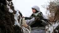 A serviceman stands in a trench on the territory controlled by pro-Russian militants near frontline with Ukrainian government forces in Slavyanoserbsk, Luhansk region, eastern Ukraine, Tuesday, Jan. 25, 2022. Ukraine's leaders sought to reassure the nation that a feared invasion from neighboring Russia was not imminent, even as they acknowledged the threat is real and prepared to accept a shipment of American military equipment Tuesday to shore up their defenses. (AP Photo/Alexei Alexandrov)