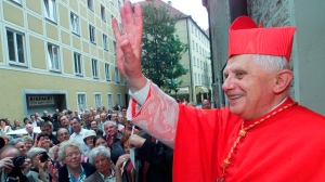 FILE - The Vatican's Prefect for the Doctrine of the Faith, Cardinal Joseph Ratzinger, later to become Pope Benedict XVI, waves to faithful following a mass on the occasion of the 50th anniversary of his priest ordination in the cathedral of Munich, southern Germany, July 8, 2001. The Vatican on Wednesday, Jan. 26, 2022 strongly defended Pope Benedict XVIâ€™s record in fighting clergy sexual abuse and cautioned against looking for â€œeasy scapegoats and summary judgments,â€ after an independent report faulted his handling of four cases of abuse when he was archbishop of Munich, Germany. (AP Photo/Diether Endlicher, File)