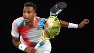 Felix Auger-Aliassime of Canada serves to Daniil Medvedev of Russia during their quarterfinal match at the Australian Open tennis championships in Melbourne, Australia, Wednesday, Jan. 26, 2022. (AP Photo/Andy Brownbill)
