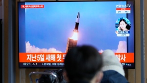 People watch a TV screen showing a news program reporting about North Korea's missile launch with a file image, at a train station in Seoul, South Korea, Thursday, Jan. 27, 2022. North Korea on Thursday fired at least two suspected ballistic missiles into the sea in its sixth round of weapons launches this month, South Korea's military said. (AP Photo/Lee Jin-man)