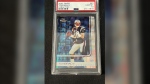 In this photo provided by Saco River Auction LLC, a 2002 Topps Finest X-Fractor card showing football quarterback Tom Brady rests inside a transparent case, Wednesday, Jan. 19, 2022, in Gorham, Maine. Troy Thibodeau from Saco River Auction estimates the card will fetch six figures when it's auctioned on Jan. 31. (Troy Thibodeau/Saco River Auction LLC via AP)