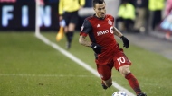 FILE - Toronto FC forward Sebastian Giovinco (10) keeps the ball in bounds as he runs up field during MLS soccer action against the Atlanta United in Toronto, Sunday, Oct. 28, 2018. THE CANADIAN PRESS/Cole Burston 