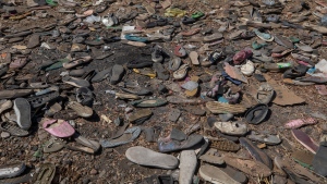 FILE - Shoes left behind belonging to Tigrayan refugees are scattered near the banks of the Tekeze River on the Sudan-Ethiopia border after Ethiopian forces blocked people from crossing into Sudan, in Hamdayet, eastern Sudan, Dec. 15, 2020. Thousands have died in Ethiopia's brutal year-long war that began in Tigray. The death toll is one of the biggest unknowns of the war. (AP Photo/Nariman El-Mofty, File) 