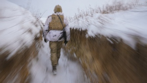 A Ukrainian serviceman walks through a trench on the front line in the Luhansk area, eastern Ukraine, Thursday, Jan. 27, 2022. The U.S. rejection of Russia's main demands to resolve the crisis over Ukraine left "little ground for optimism," the Kremlin said Thursday, but added that dialogue was still possible. (AP Photo/Vadim Ghirda)