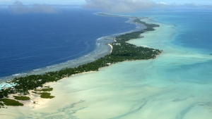 FILE - In this March 30, 2004, file photo, Tarawa atoll, Kiribati, is seen in an aerial view. Kiribati and several other small Pacific nations were among the last on the planet to have avoided any virus outbreaks, thanks to their remote locations and strict border controls. But their defenses appear no match against the highly contagious omicron variant. (AP Photo/Richard Vogel, File)