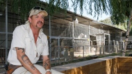 FILE - Joseph Maldonado-Passage, also known as Joe Exotic, is seen at the zoo he used to run in Wynnewood, Okla., on Aug. 28, 2013. A federal judge is set to decide a new sentence for Maldonado-Passage after an appeals court ruled last year that the prison term he's serving on a murder-for-hire conviction should be shortened. (AP Photo/Sue Ogrocki, File)