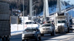 Protesters and supporters drive over the Nipigon Bridge on the Trans Canada Highway as part of a trucking convoy against COVID-19 vaccine mandates in Nipigon, Ont., on Thursday, Jan. 27, 2022. THE CANADIAN PRESS/David Jackson