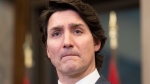 Canadian Prime Minister Justin Trudeau listens to a question as he speaks with the media following a cabinet retreat, Wednesday, Jan. 26, 2022 in Ottawa. Trudeau says Canada is extending its mission to train Ukrainian soldiers by three years. THE CANADIAN PRESS/Adrian Wyld