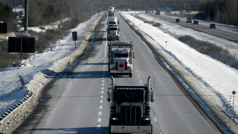 Trucks participating in a cross-country convoy protesting a federal vaccine mandate for truckers, make their way along Highway 416 into Ottawa, Friday, Jan. 28, 2022. THE CANADIAN PRESS/Justin Tang 