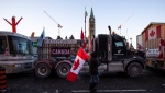 Trucks participating in a cross-country convoy protesting measures taken by authorities to curb the spread of COVID-19 are parked on Wellington Street in front of Parliament Hill in Ottawa, on Friday, Jan. 28, 2022. THE CANADIAN PRESS/Justin Tang