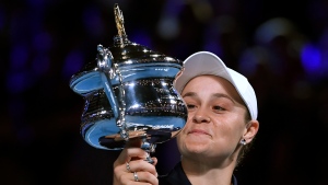 Ash Barty of Australia holds the Daphne Akhurst Memorial Cup aloft after defeating Danielle Collins of the U.S., in the women's singles final at the Australian Open tennis championships in Saturday, Jan. 29, 2022, in Melbourne, Australia. (AP Photo/Andy Brownbill)
