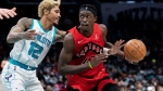 Charlotte Hornets guard Kelly Oubre Jr. (12) tries to knock the ball away from Toronto Raptors forward Pascal Siakam (43) during the second half of an NBA basketball game in Charlotte, N.C., Monday, Feb. 7, 2022. (AP Photo/Jacob Kupferman)