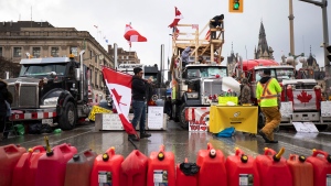 Protestors gather along Wellington Street as a protest against COVID-19 restrictions that has been marked by gridlock and the sound of truck horns reaches its 14th day, in Ottawa, Thursday, Feb. 10, 2022. THE CANADIAN PRESS/Nick Iwanyshyn