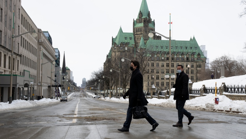 Prime Minister Justin Trudeau walks across an empty Wellington St. to a news conference, Monday, February 21, 2022 in Ottawa. THE CANADIAN PRESS/Adrian Wyld