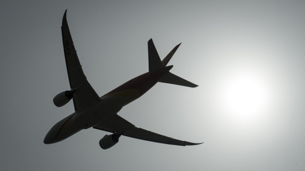 A plane is silhouetted as it takes off from Vancouver International Airport in Richmond, B.C., on May 13, 2019.. THE CANADIAN PRESS/Jonathan Hayward