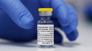A vial of the Phase 3 Novavax coronavirus vaccine prepared for use in a trial at St. George's University hospital in London, Oct. 7, 2020. (AP Photo/Alastair Grant, File)