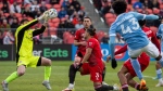 Toronto FC goalkeeper Alex Bono, left, saves a shot from New York City FC's Talles Magno, right, during first half MLS soccer action in Toronto, Saturday, April 2, 2022. THE CANADIAN PRESS/Chris Young 