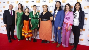 Writer and Director Danis Goulet (fourth from left) stands with (left to right) Producers Paul Barkin and Tara Woodbury, actors Brooklyn Letexier-Hart, Violet Nelson, Jordan Bullchild, Suzanne Cyr, and Gail Maurice, as they pose for a photo on the red carpet to promote the film "Night Raiders" in Toronto during the Toronto International Film Festival on Friday, Sept. 10, 2021. Indigenous sci-fi thriller "Night Raiders" and suburban drama "Scarborough," are tied as the top winners in the film categories heading into the marquee bash at the Canadian Screen Awards. THE CANADIAN PRESS/Chris Young