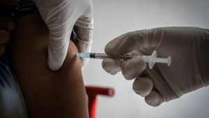 A woman receives her third dose of vaccine for COVID-19 at a private vaccination center in Gauhati, India, Sunday, April 10, 2022. (AP Photo/Anupam Nath) 