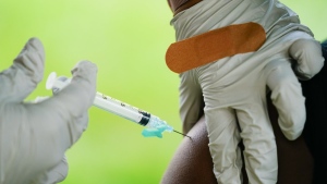 FILE - In this Sept. 14, 2021, file photo, a health worker administers a dose of a Pfizer COVID-19 vaccine during a vaccination clinic in Reading, Pa. Pfizer, Thursday, April 14, 2022, wants to expand its COVID-19 booster shots to healthy 5- to 11-year-olds. U.S. health authorities already urge everyone 12 and older to get one booster dose for the best protection. And those 50 and older have the option of a second booster. (AP Photo/Matt Rourke, File)