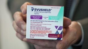 Scott Madow, a heath services manager at a University of Washington Medicine clinic, poses for a photo as he holds a box of AstraZeneca's Evusheld, the first set of antibodies grown in a lab to prevent COVID-19, in Seattle, Thursday, Jan. 20, 2022. Health Canada has approved AstraZeneca's COVID-19 antibody combination to prevent symptomatic infection for immunocompromised people. THE CANADIAN PRESS/AP-Ted S. Warren