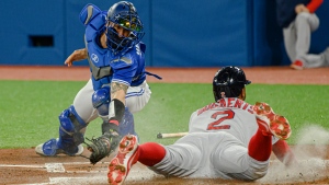 Boston Red Sox shortstop Xander Bogaerts (2) slides into home base to score during first inning MLB baseball action against the Toronto Blue Jays in Toronto on Wednesday, April 27, 2022. THE CANADIAN PRESS/Christopher Katsarov